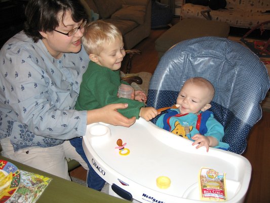 Mommy and Tim giving Cole his first food (11-23-2005 18:40)