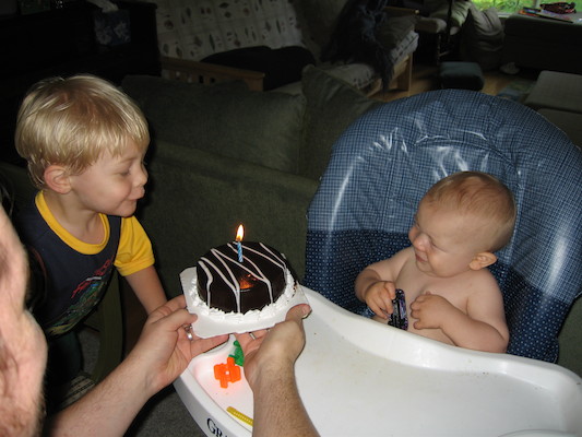 Tim helping Cole blow out his birthday cake (06-16-2006)