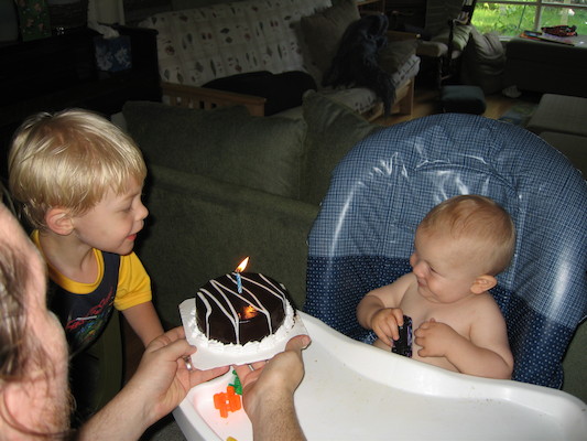 Tim helping Cole blow out his birthday cake (06-16-2006)