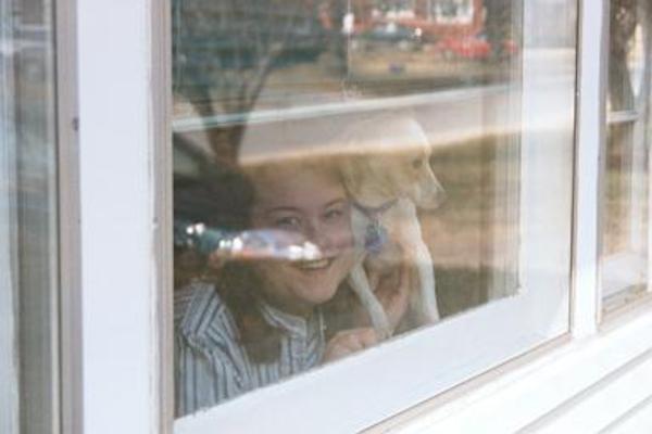 Xine and Emily watching through the window