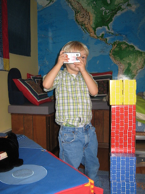 Tim taking a picture next to his robot (11-17-2006 12:41)