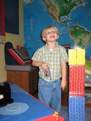 Tim taking a picture next to his robot (11-17-2006 12:41)
