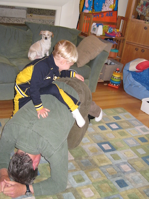 Tim riding Grandad, Emily watches (05-18-2007 17:08)