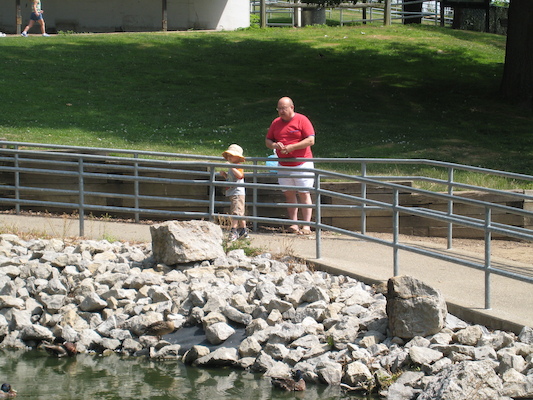 Tim and Poppy feeding the ducks (06-16-2007 11:10)