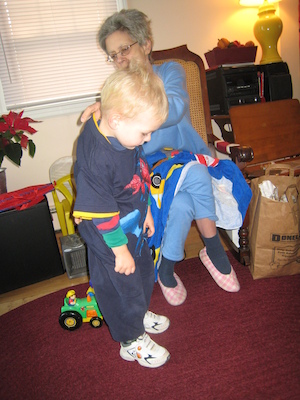 Nea putting a Spider Man shirt on Cole (12-25-2007 10:35)