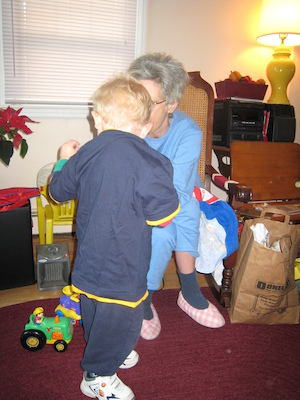 Nea putting a Spider Man shirt on Cole (12-25-2007 10:35)