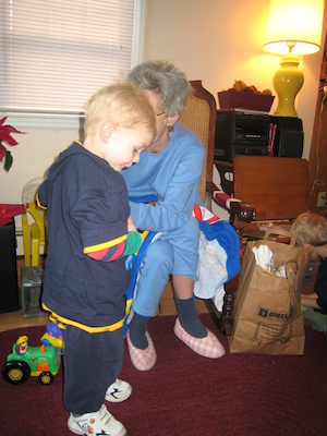 Nea putting a Spider Man shirt on Cole (12-25-2007 10:35)