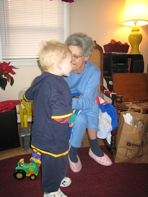Nea putting a Spider Man shirt on Cole (12-25-2007 10:35)