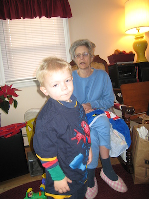 Nea putting a Spider Man shirt on Cole (12-25-2007 10:35)