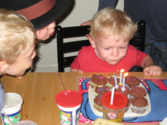 Cole blowing out candles with Tim and Emma (06-15-2008 17:43)