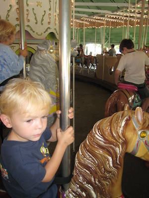 Cole and Tim on the merry-go-round (08-27-2008 11:53)