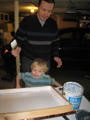 Cole and Ben painting beehives (04-10-2009 08:03)