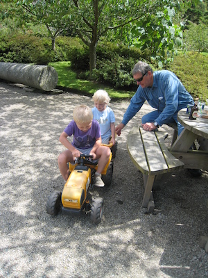 Tim and Cole on a tractor, Granddad assists (07-12-2009 06:57)