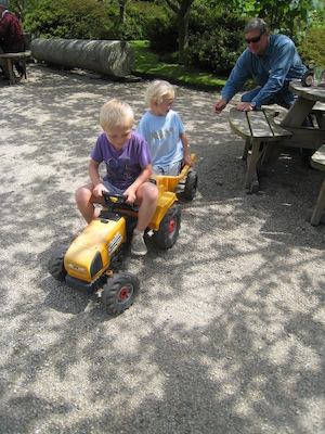 Tim pulling Cole on a tractor (07-12-2009 06:57)