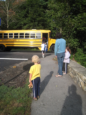 Tim getting on the bus while Cole watches (09-14-2009 07:41)