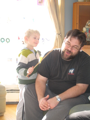 Cole using the back-scratcher on Juj (01-16-2010 11:43)