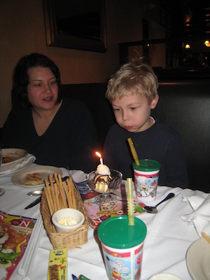 Tim blowing out his candle with Xine (03-01-2010 17:56)
