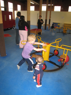 Cole pushing the merry-go-round (03-03-2010 13:42)