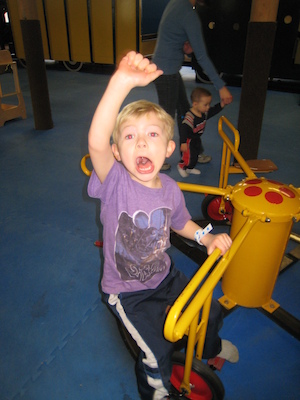 Cole riding the merry-go-round (03-03-2010 13:42)