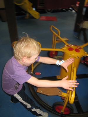 Cole pushing the merry-go-round (03-03-2010 13:42)