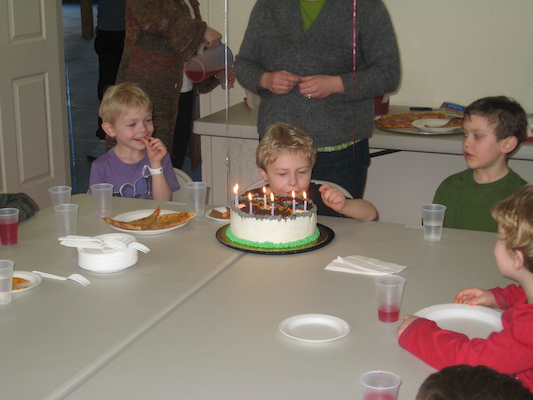Cole, Tim blowing out candles, Douglas, & Kirk (03-03-2010 15:05)