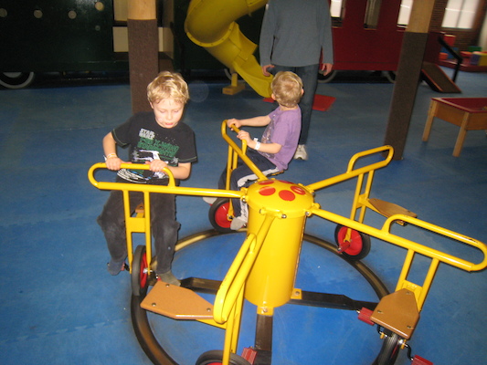 Tim and Cole riding the merry-go-round (03-03-2010 16:30)