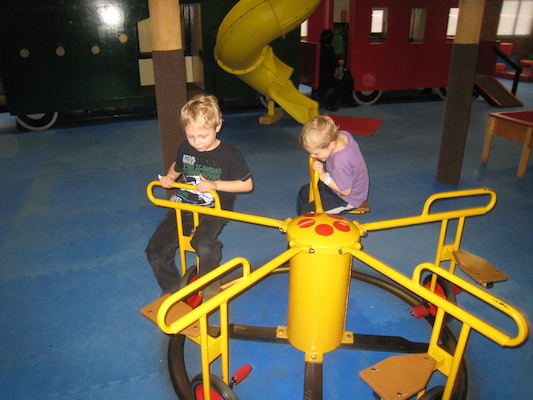 Tim and Cole riding the merry-go-round (03-03-2010 16:31)