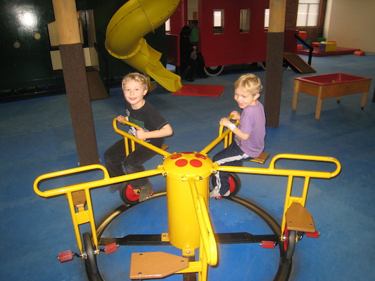 Tim and Cole riding the merry-go-round (03-03-2010 16:31)