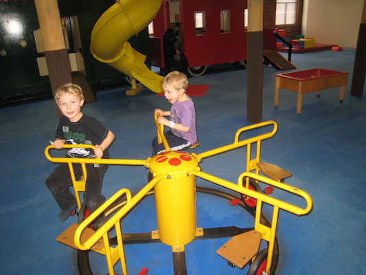 Tim and Cole riding the merry-go-round (03-03-2010 16:31)