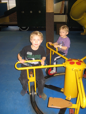Tim and Cole riding the merry-go-round (03-03-2010 16:31)