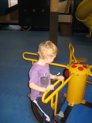 Tim and Cole riding the merry-go-round (03-03-2010 16:31)