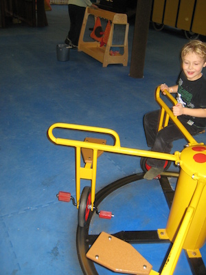 Tim and Cole riding the merry-go-round (03-03-2010 16:31)