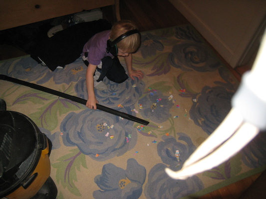 Cole vacuuming up paper (03-03-2010 17:59)