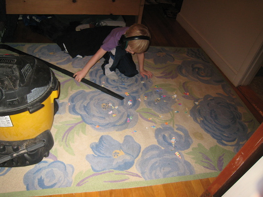 Cole vacuuming up paper (03-03-2010 17:59)