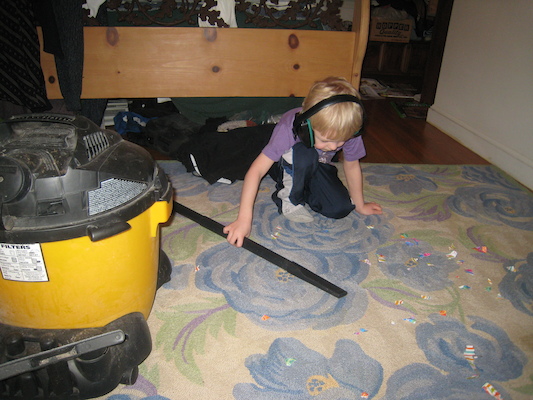 Cole vacuuming up paper (03-03-2010 17:59)