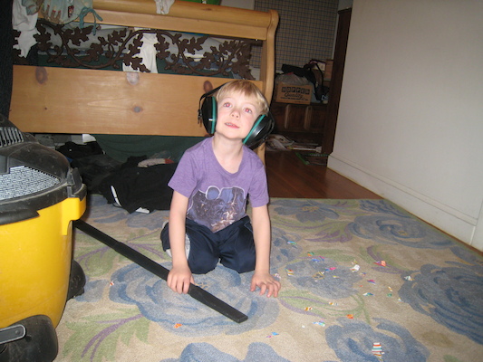 Cole vacuuming up paper (03-03-2010 17:59)