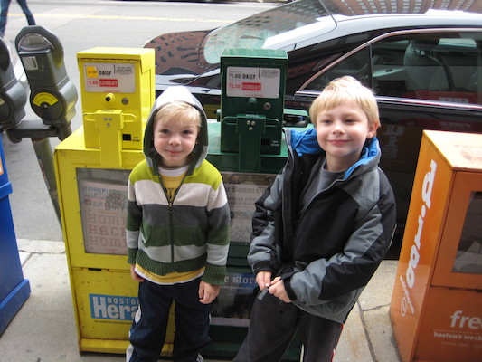 Cole and Tim by a newspaper box (03-12-2010 14:49)