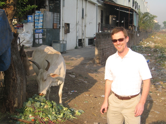 Mark and a cow by the road near the hotel (03-17-2010 21:32)