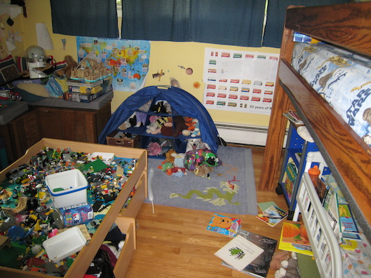 Emily hiding with the stuffed animals (06-23-2010 12:08)