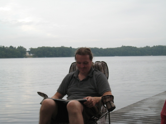 Ben reading on the dock (07-14-2010 18:10)