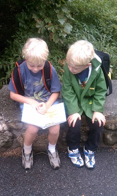 Tim reading to Cole at the bus stop (09-30-2010 08:38)