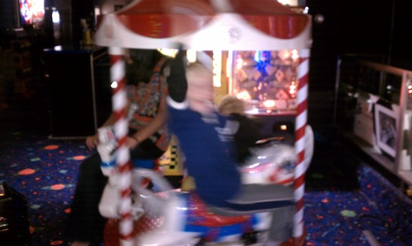 Cole and Tim ride the mini carousel (11-06-2010 17:57)