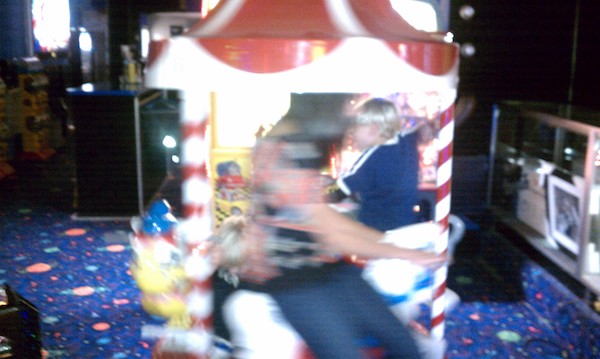 Cole and Tim ride the mini carousel (11-06-2010 17:57)