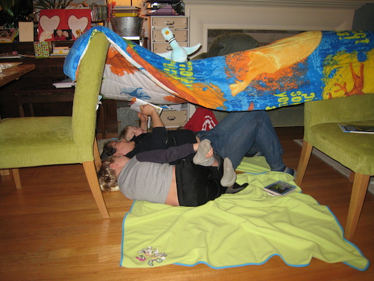Xine reading to Tim and Cole in a tent (03-09-2011 18:44)