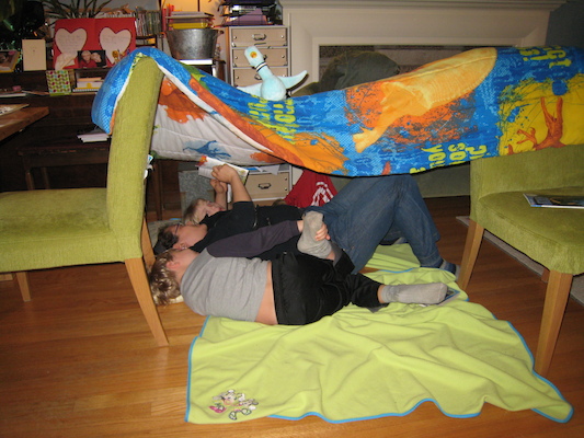 Xine reading to Tim and Cole in a tent (03-09-2011 18:45)
