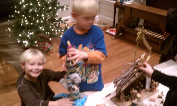 Tim and Cole bringing odd animals to the creche (12-24-2010 17:06)