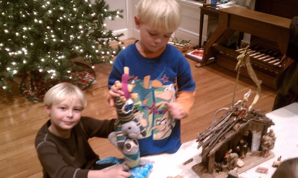 Tim and Cole bringing odd animals to the creche (12-24-2010 17:06)