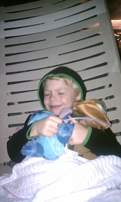 Cole snuggling his animals at the fireworks (03-01-2011 20:03)