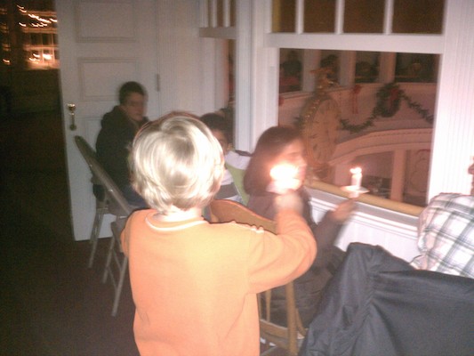 Tim helping light candles (12-24-2011 16:58)
