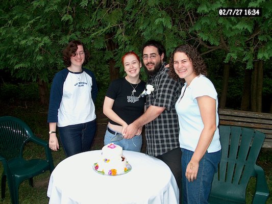 Abby, Beth, Corey and Rachel around cake